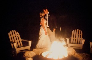 Picture of Bride and Groom kissing by a bonfire at longmeadow event center